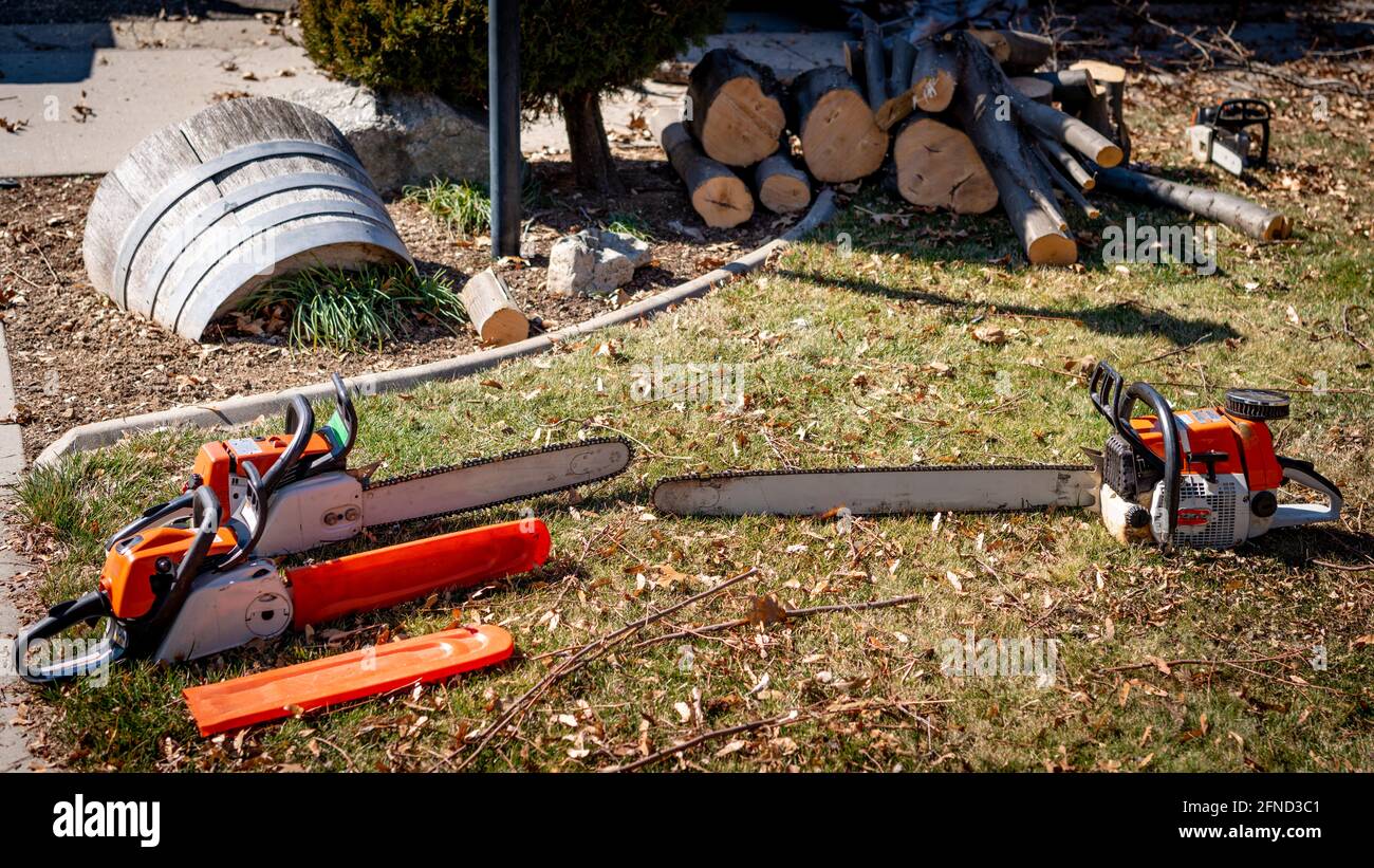 Lumberjack’s chainsaws set on the ground Stock Photo