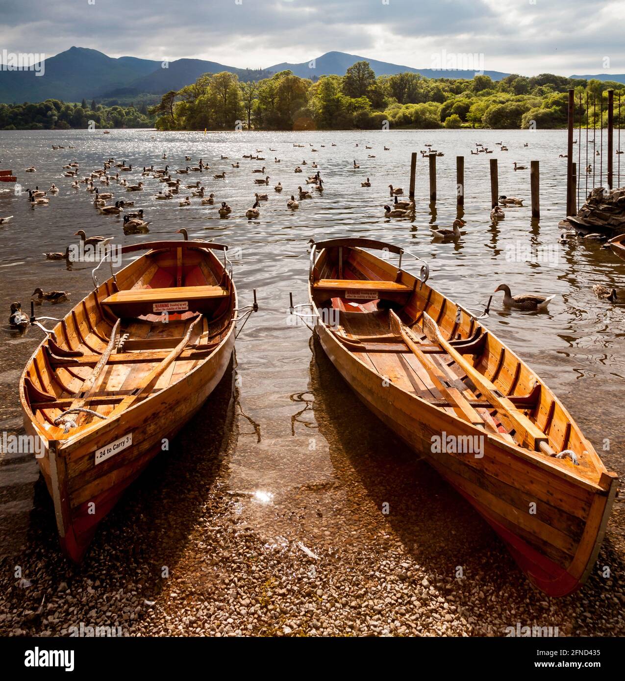 Wooden Rowing Boats on shore of Derwent Water in The English Lake ...