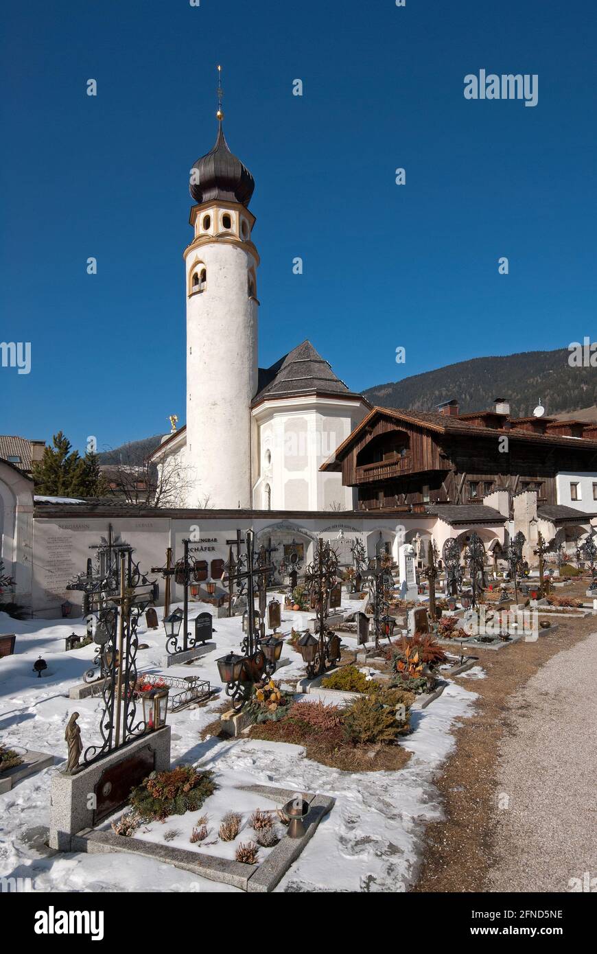 Cemetery and San Michael parish church with cylindrical bell tower in San Candido (Innichen), Pusteria Valley, Trentino-Alto Adige, Italy Stock Photo