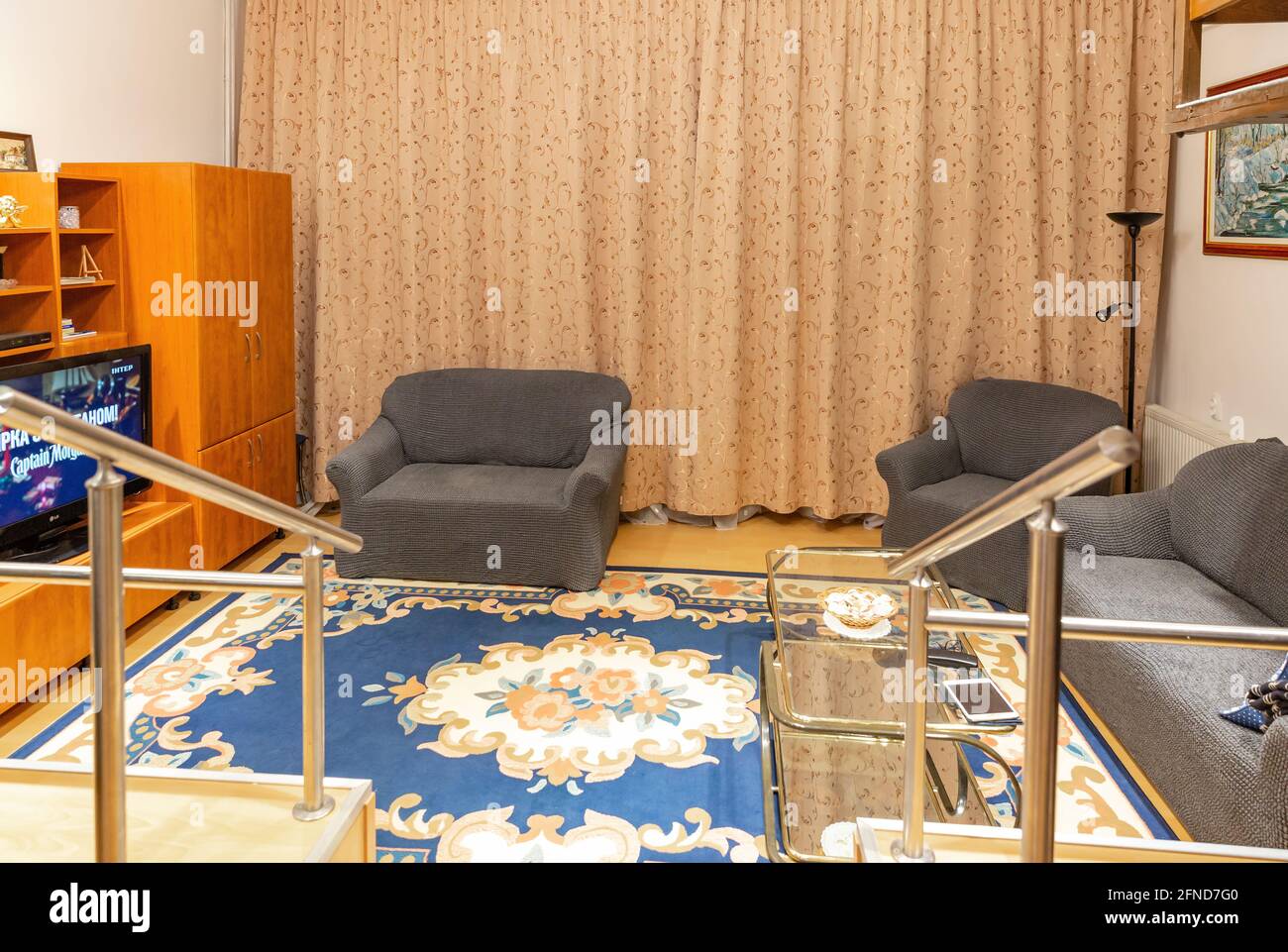 Nyiregyhaza, Hungary. January 05, 2020: Cozy living room interior with large floral carpet. Stock Photo