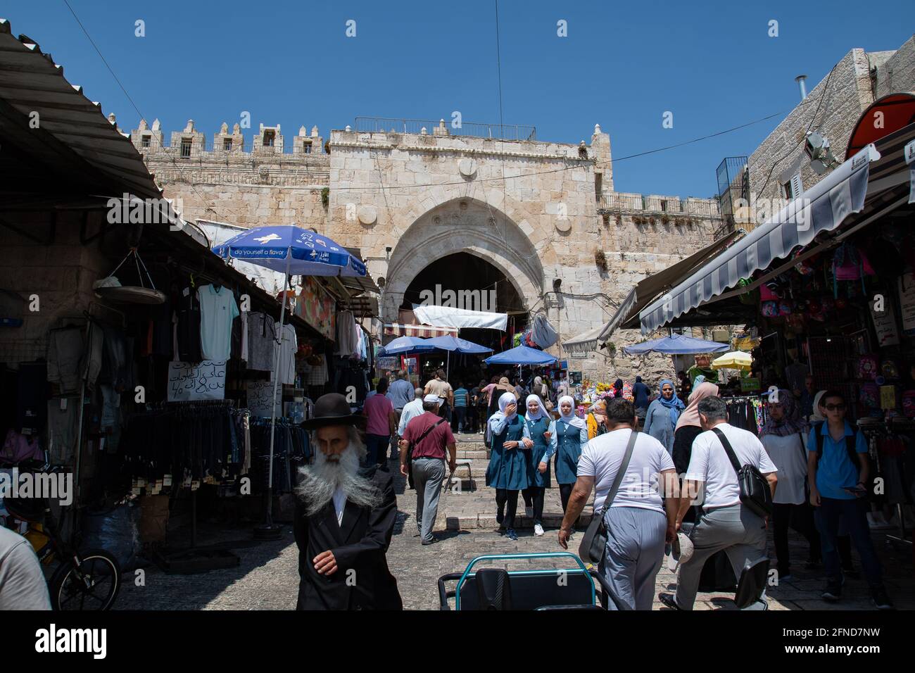 People walking Damascus Gate in the Muslim Quarter of the Old City of Jerusalem. Stock Photo