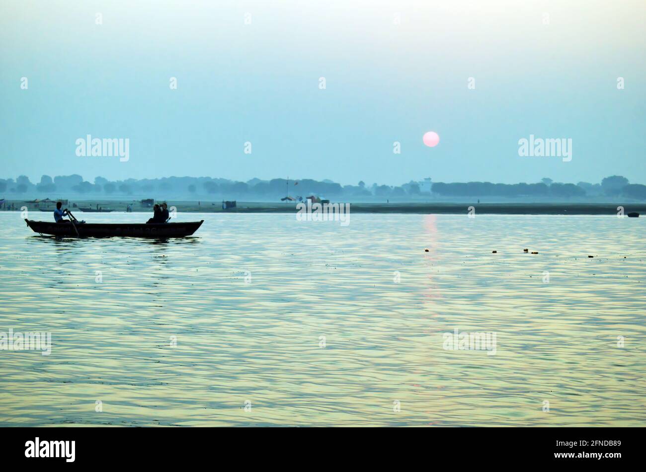 Pilgrims floating by boat of the sacred Ganges river. Sunrise in ...