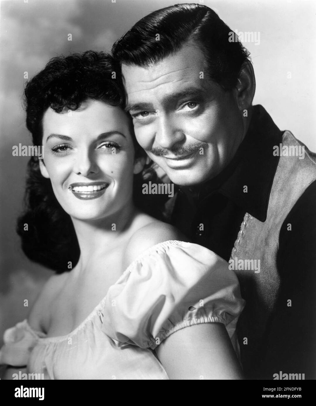 CLARK GABLE and JANE RUSSELL Publicity Portrait in THE TALL MEN 1955 director RAOUL WALSH from the novel by Heck Allen screenplay Sydney Boehm and Frank S. Nugent music Victor Young costumes Travilla Twentieth Century Fox Stock Photo