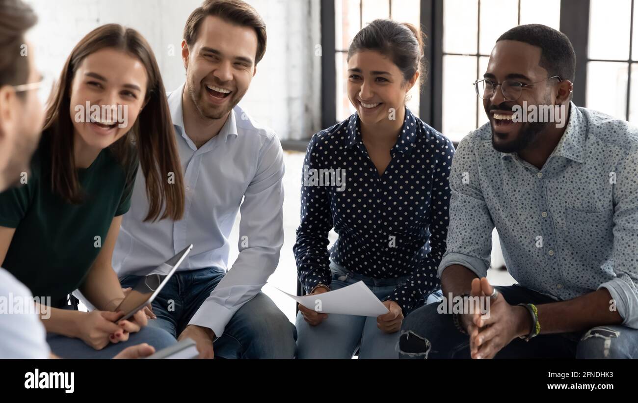 Coach or group leader telling funny story or joke Stock Photo