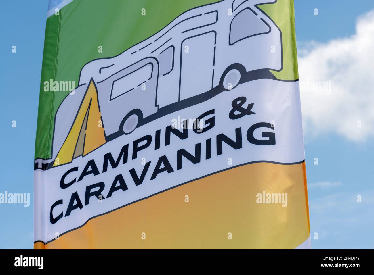 Camping and caravaning flag flying against blue sky Stock Photo