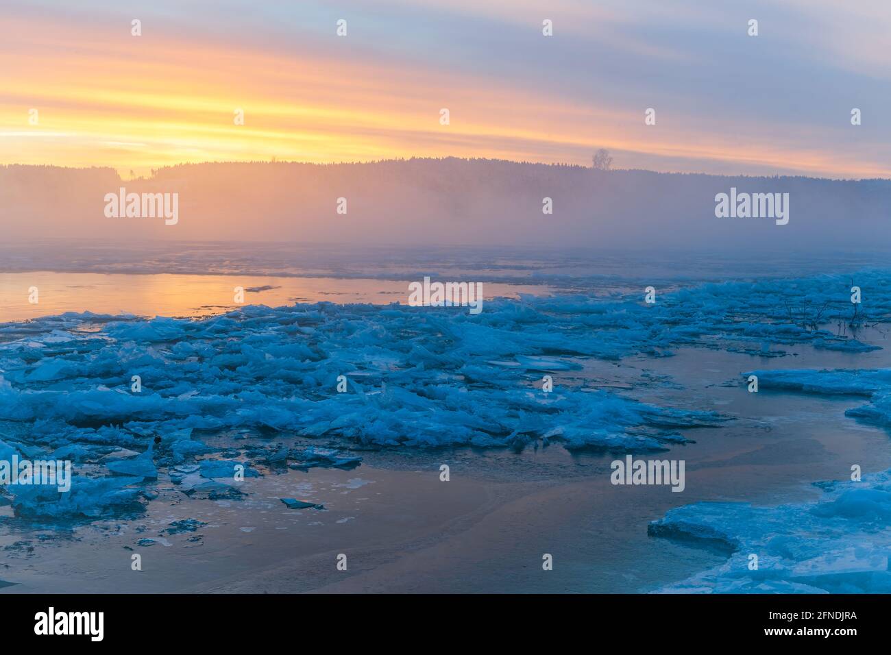 Colorful sunrise at icy river Stock Photo