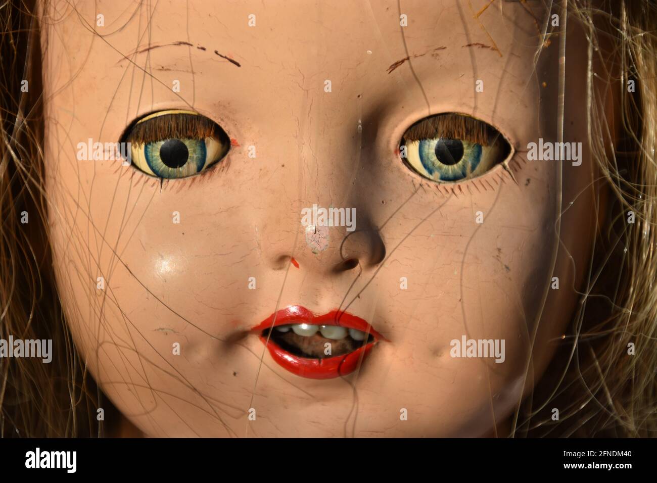 A closeup of a creepy old doll face Stock Photo