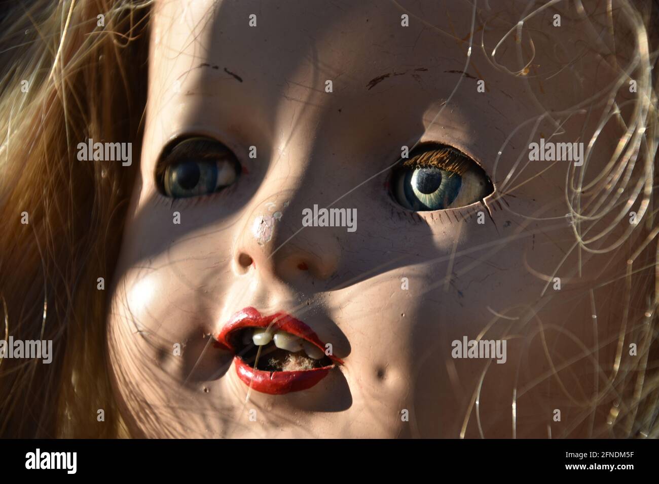 A closeup of a creepy old doll face Stock Photo