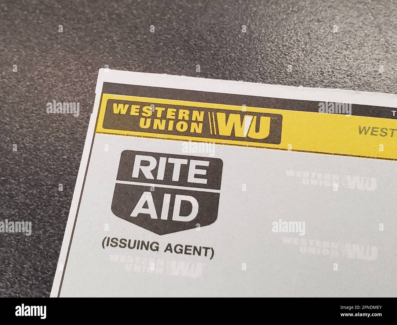 High-angle close-up of the corner of a paper product with Western Union and Rite Aid logos, resting on a Rite Aid drug store countertop in Walnut Creek, California, January 12, 2021. () Stock Photo