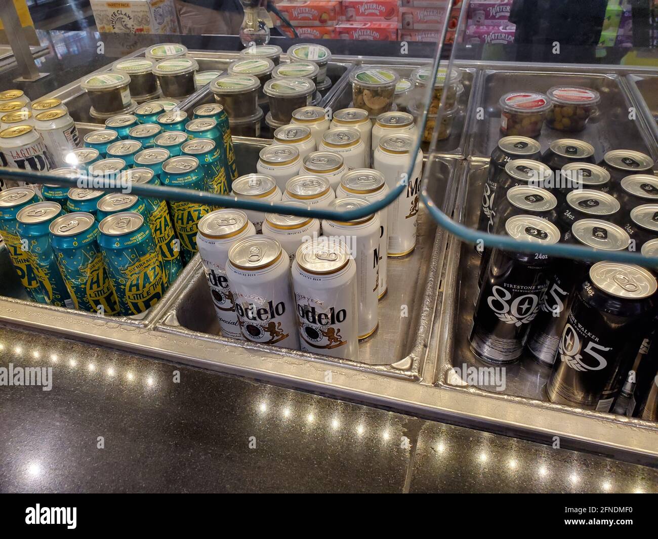 High-angle close-up of cans of beer and small condiment tubs, in chilled buffet trays in a Whole Foods Market in Lafayette, California, January 8, 2021. () Stock Photo