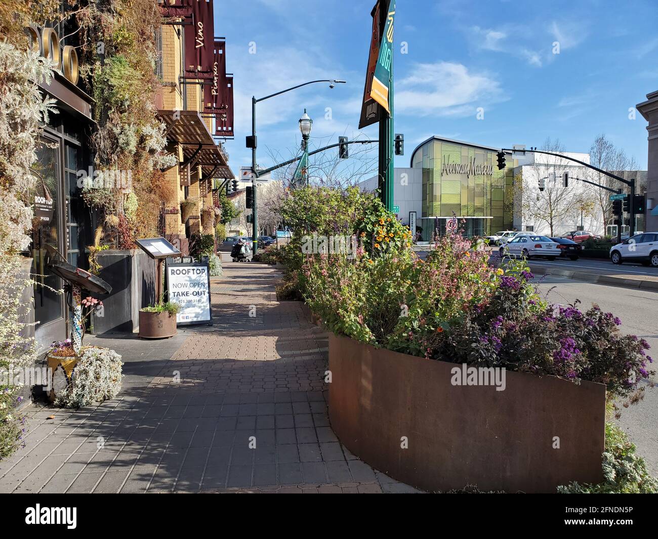Photograph of the sidewalk and flowers in planter boxes in front of the Rooftop Restaurant and Bar in Walnut Creek, California, January 15, 2021. () Stock Photo