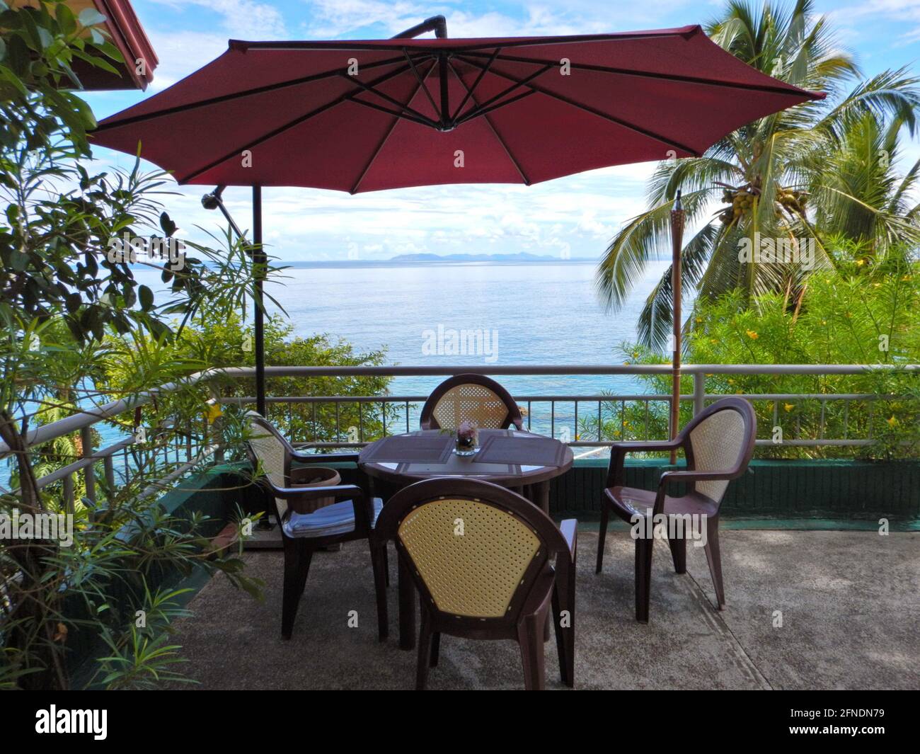 Table and chairs with an umbrella on a balcony overlooking the Pacific ocean at Eagle Point