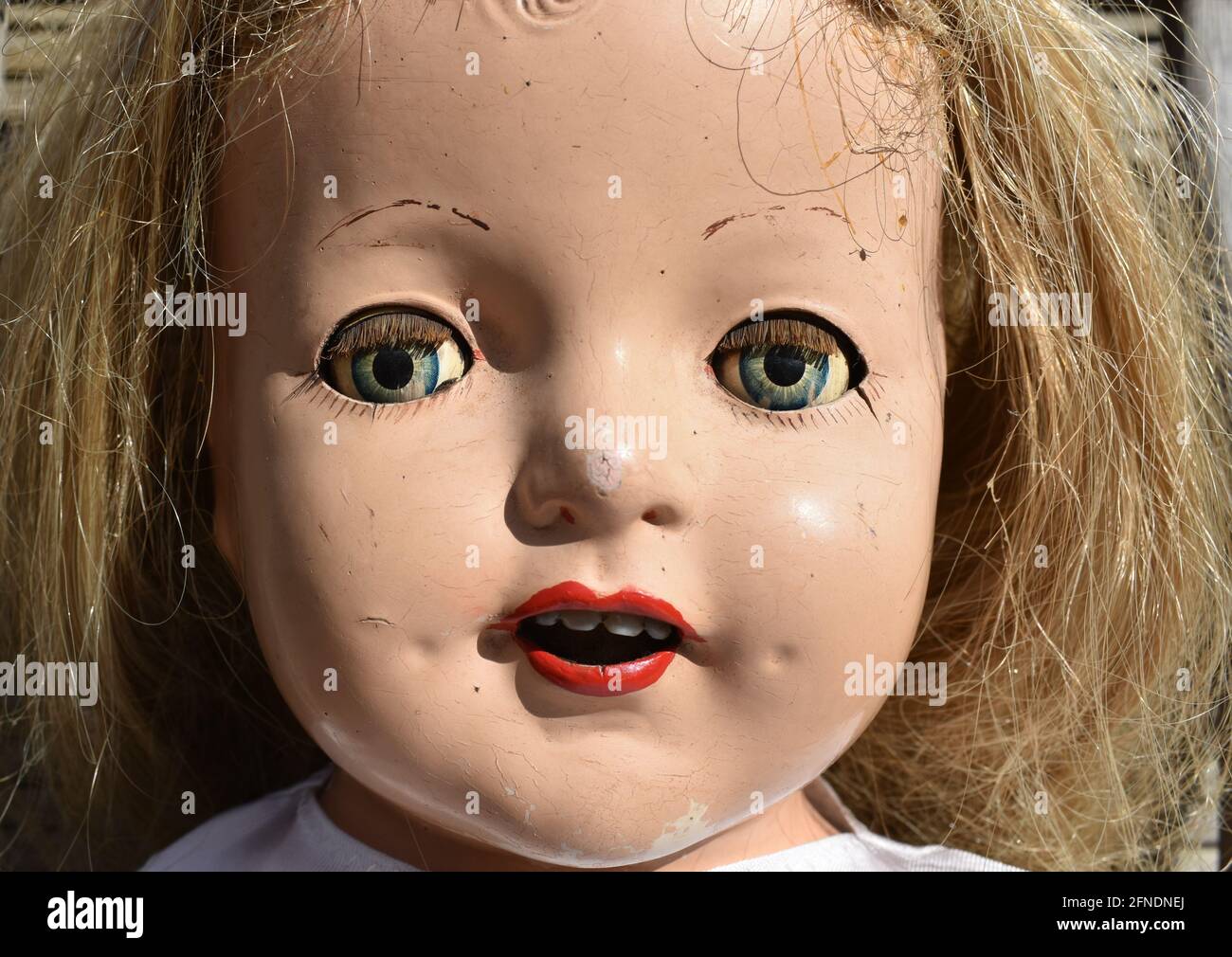 A closeup of a creepy old doll face Stock Photo