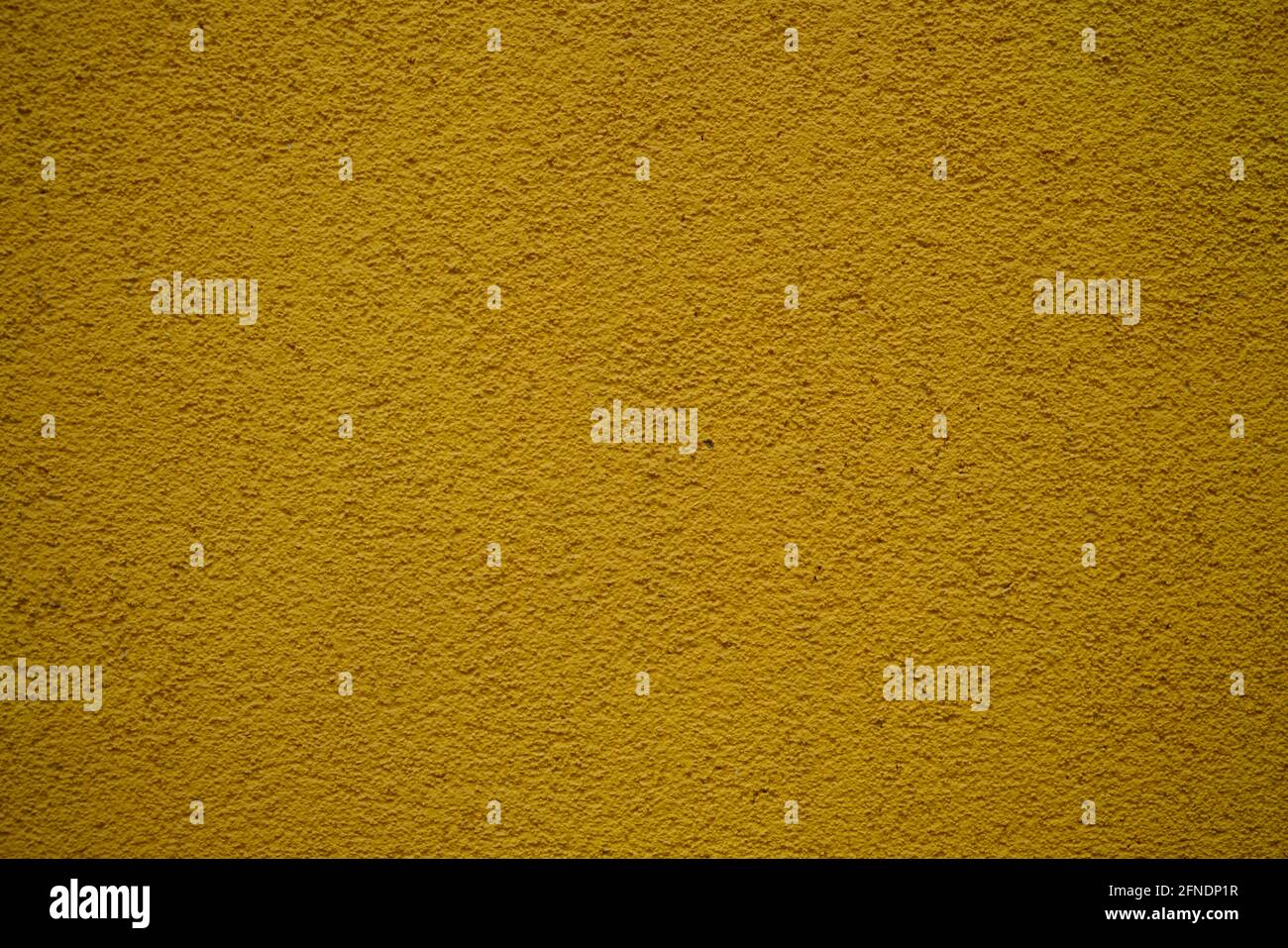 Closeup of a rough yellow surface under the lights - great for wallpapers Stock Photo