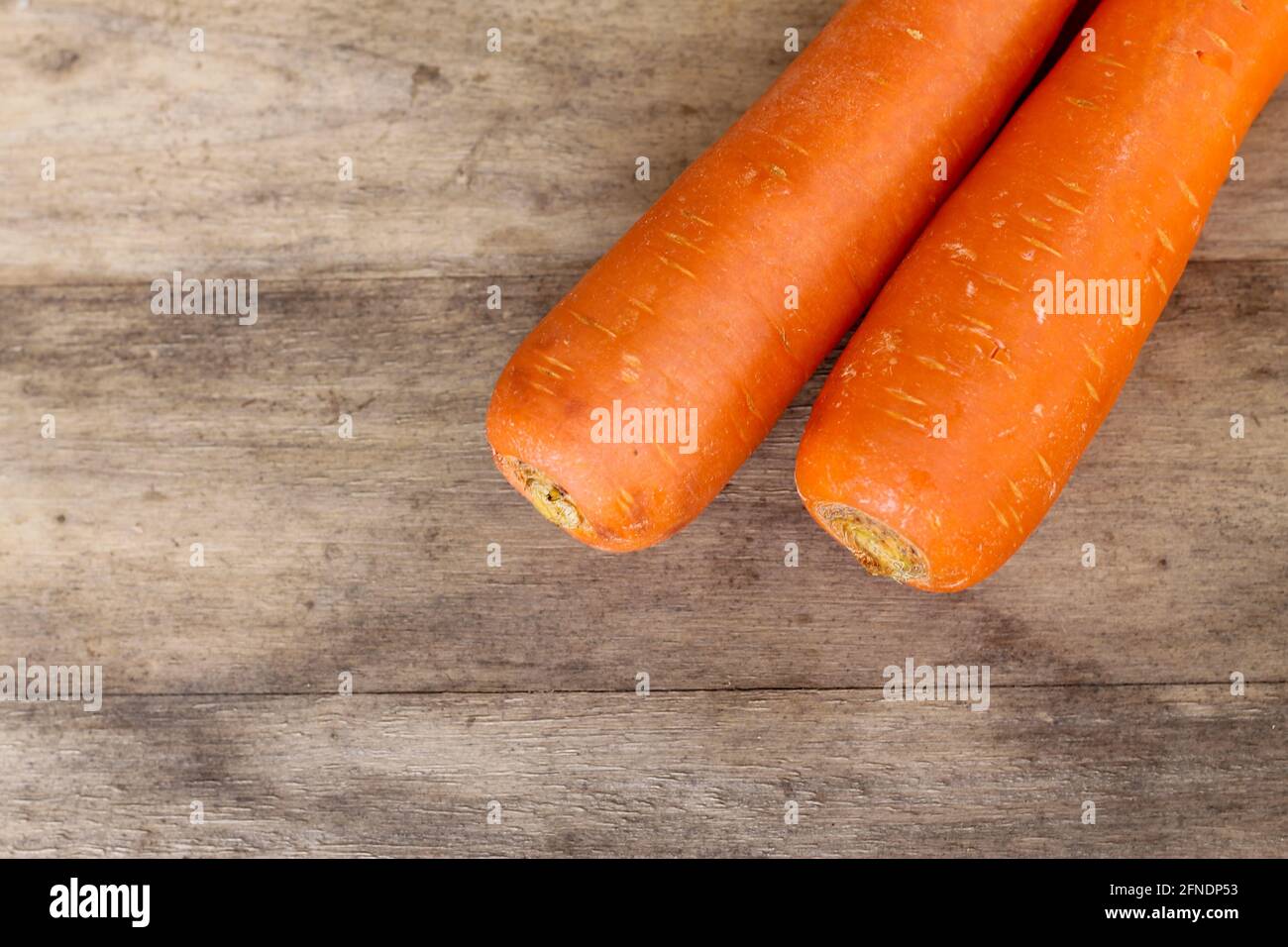 two carrots on an old wood background looks very beautiful Stock Photo