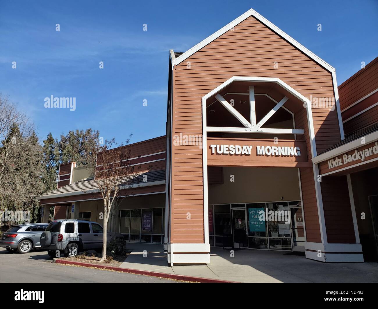 Low-angle shot of 'Tuesday Morning' and 'Kidz Backyard' signs at a strip mall on Camino Ramon in Danville, California, March 2, 2021. () Stock Photo