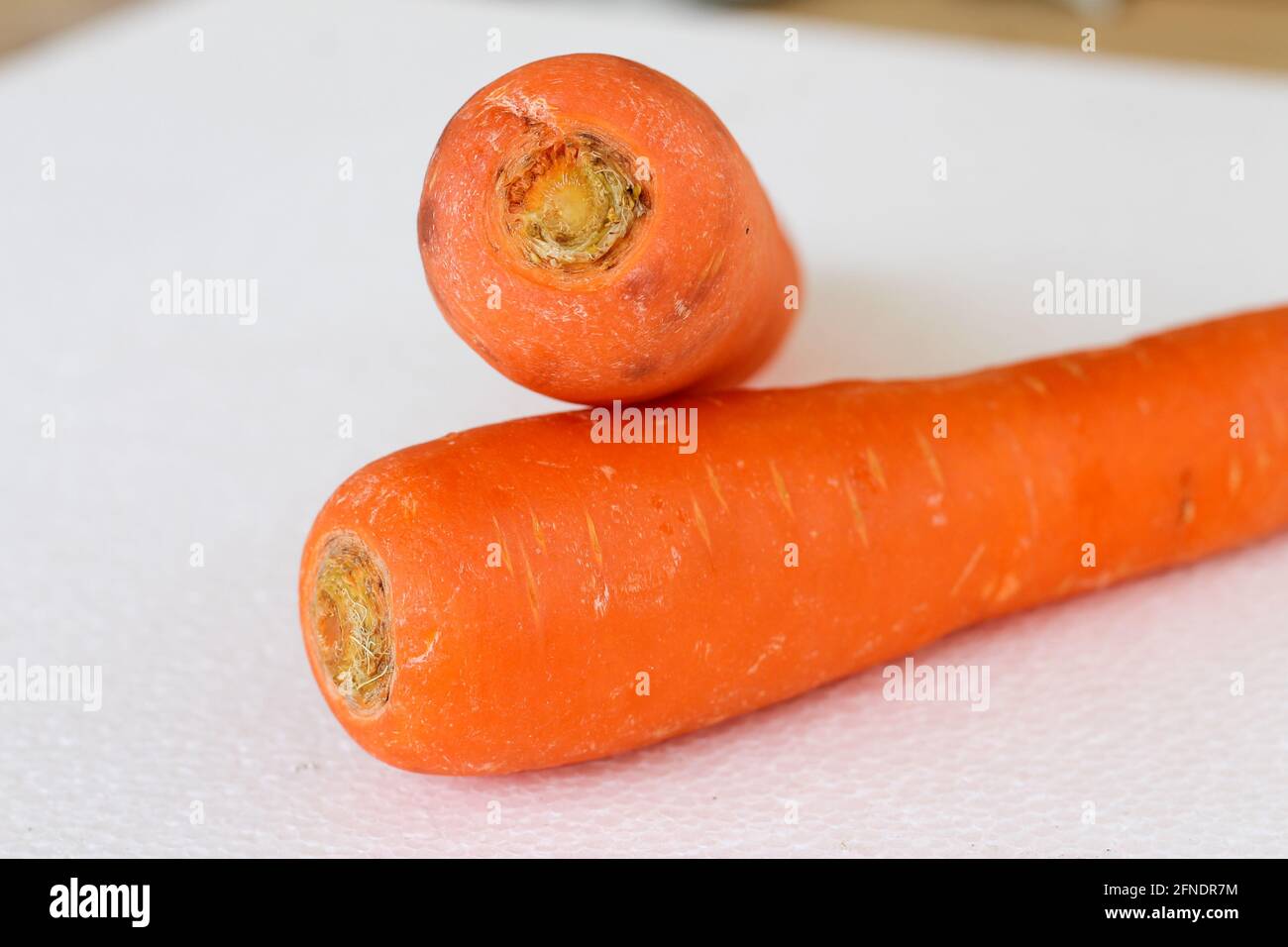 two carrots on white background which one on top Stock Photo