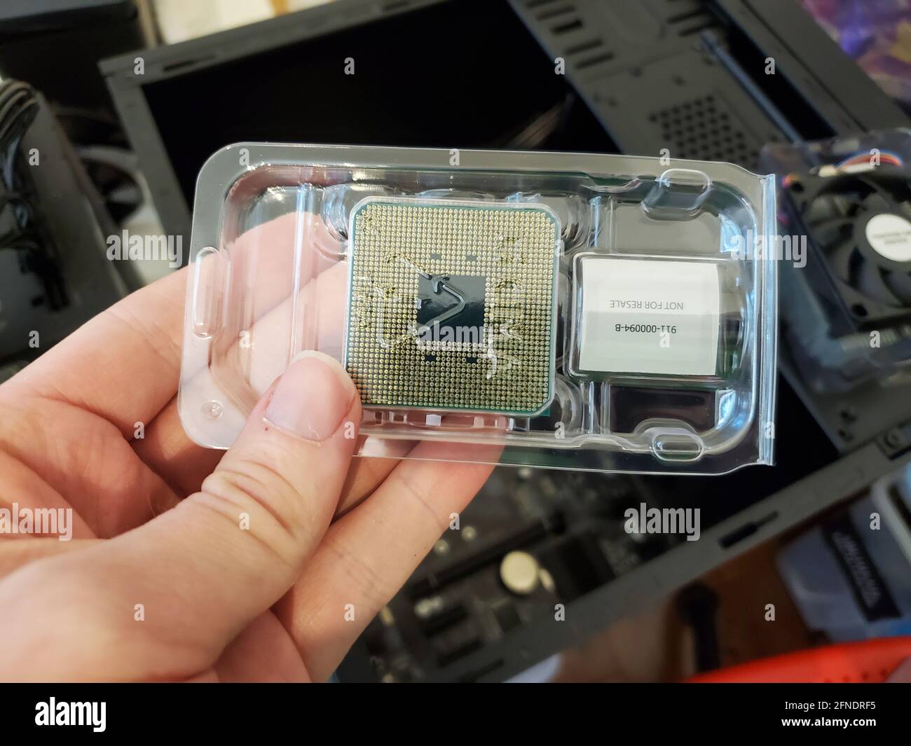 Highangle closeup of a hand holding a plasticpackaged central