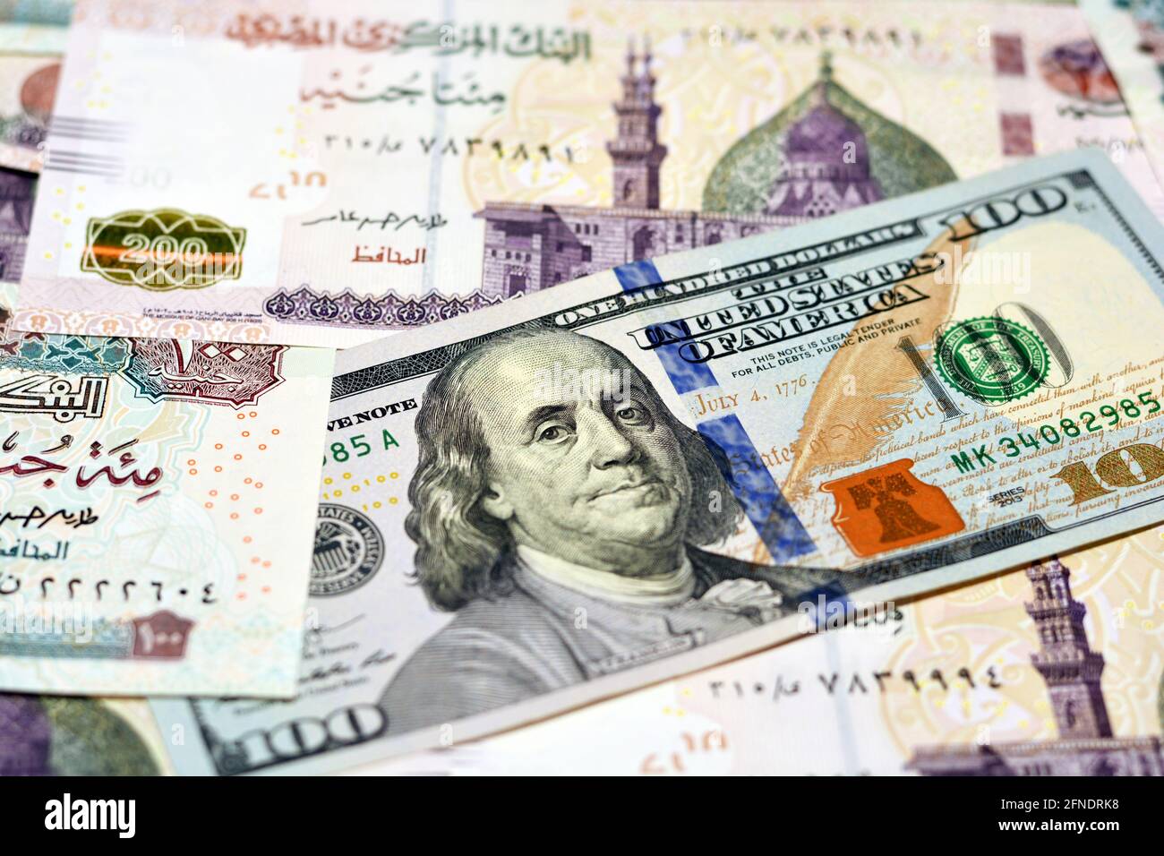 Egypt national currency with USA dollar banknote backdrop. Money