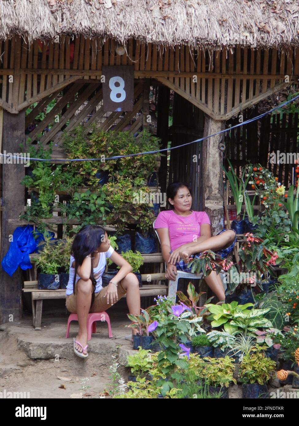 Two beautiful young Asian Filipino women sitting and chatting near Mambukal Hot Spring Resort, Murcia, Negros Occidental, Philippines Stock Photo