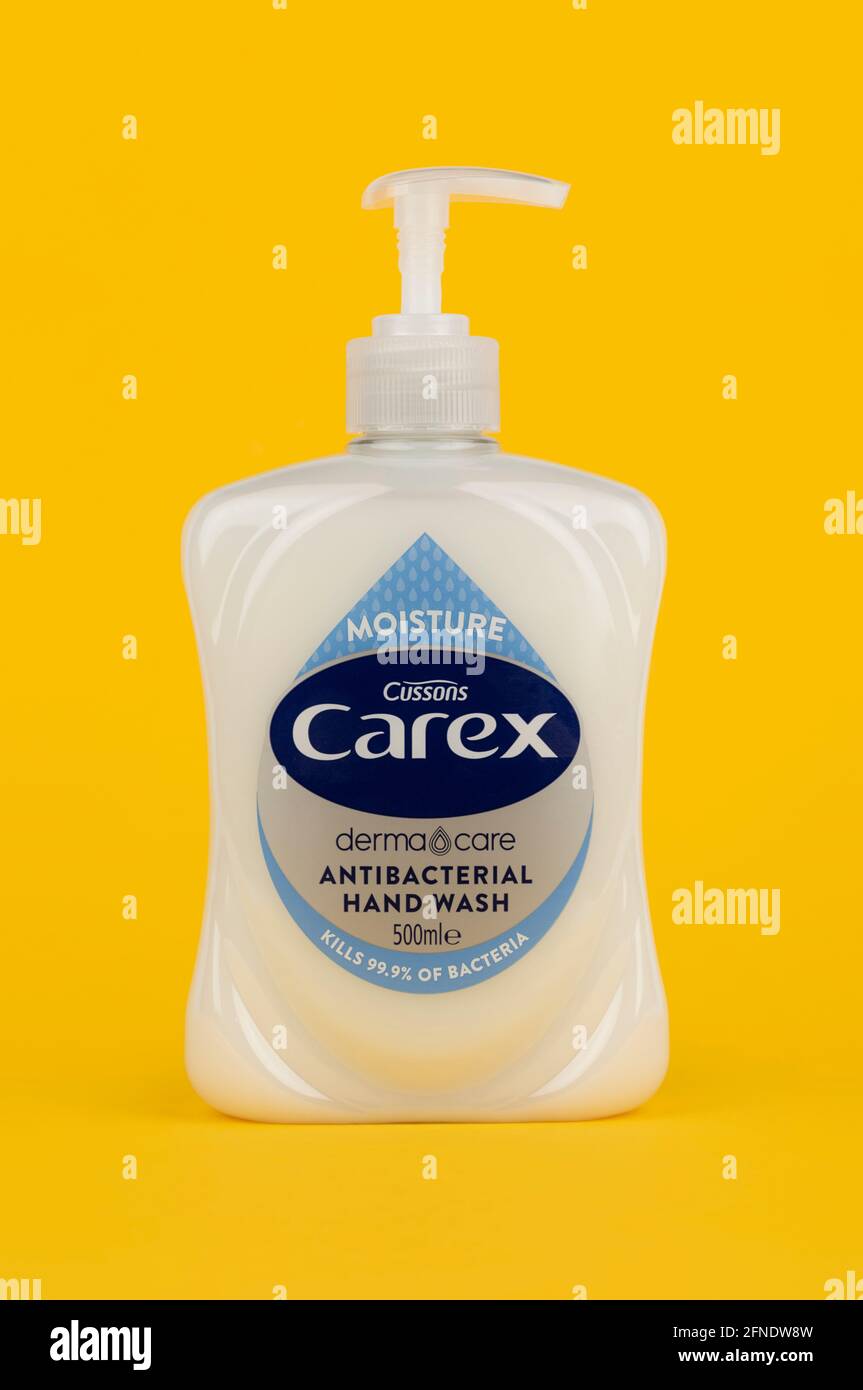 A bottle of Cussons Carex handwash shot on a yellow background. Stock Photo