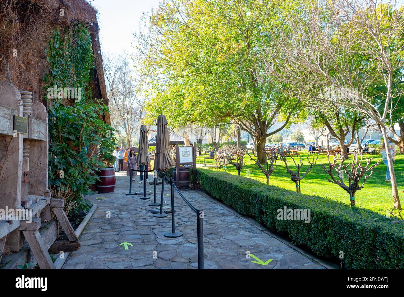 Photograph of the brick path leading past the antique wine press to the wine tasting cellar at V. Sattui Winery in St Helena, California, February 6, 2021. () Stock Photo