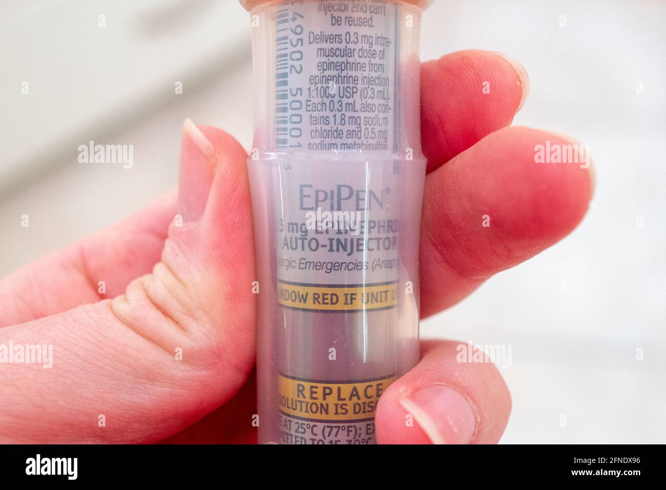 Close up of an EpiPen logo on an epinephrine autoinjector held in a