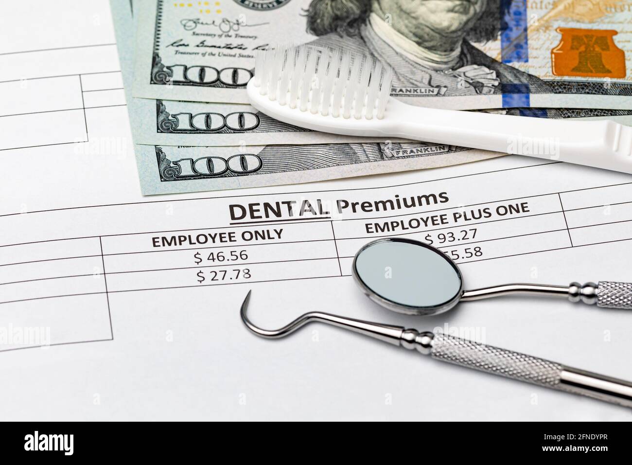 Dental insurance bill with toothbrush and dental tools. Concept of oral health, exam and teeth cleaning Stock Photo