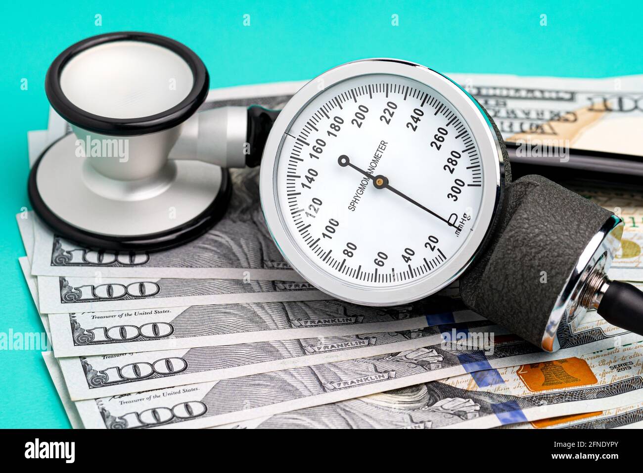 Stethoscope, sphygmomanometer and cash money. Healthcare, health insurance and medical bills concept. Stock Photo