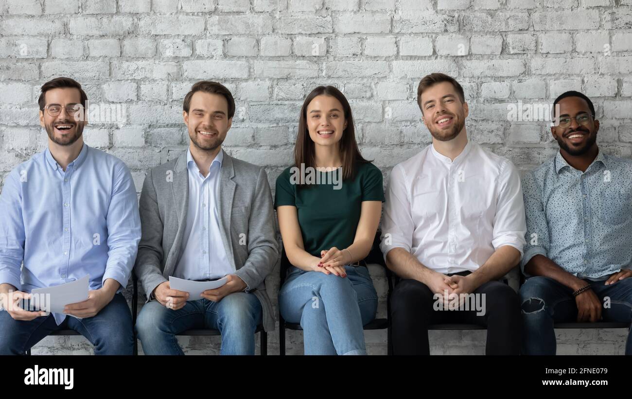 Confident diverse vacancy applicants sitting in queue Stock Photo