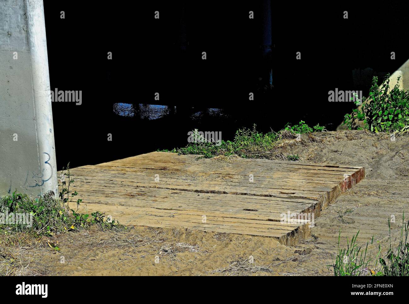 large wooden beams place on the Alameda Creek under the 880 freeway overpass in Union City, California Stock Photo