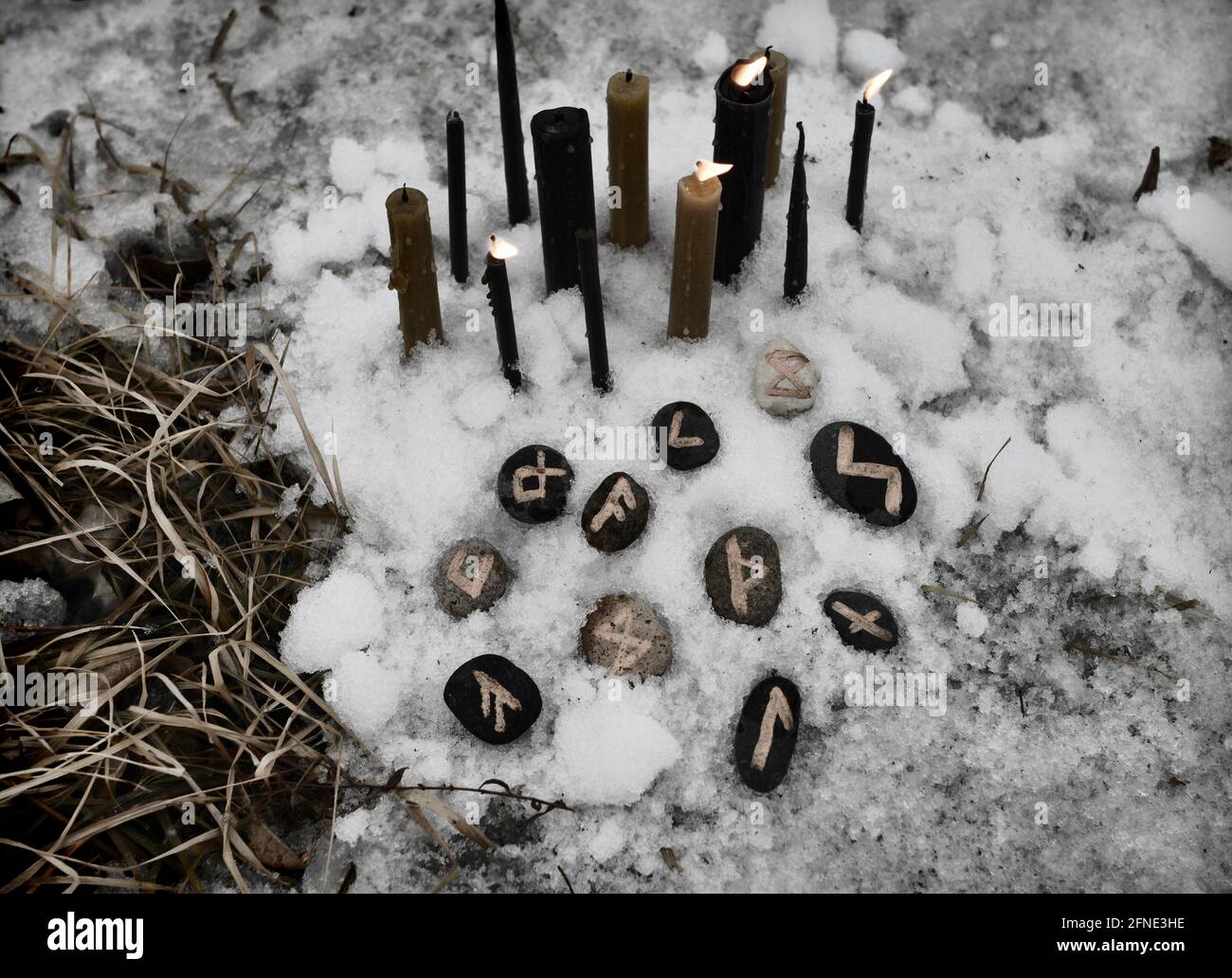 Grunge still life with candles and runes in winter outside. Esoteric ...