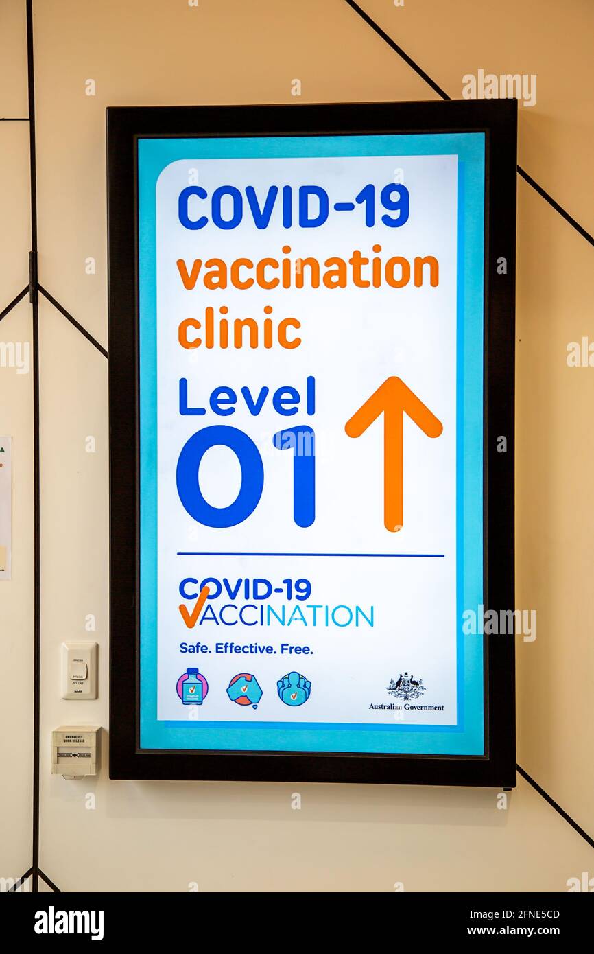 Neon sign directing people to a covid-19 vaccination clinic in Perth, Western Australia Stock Photo