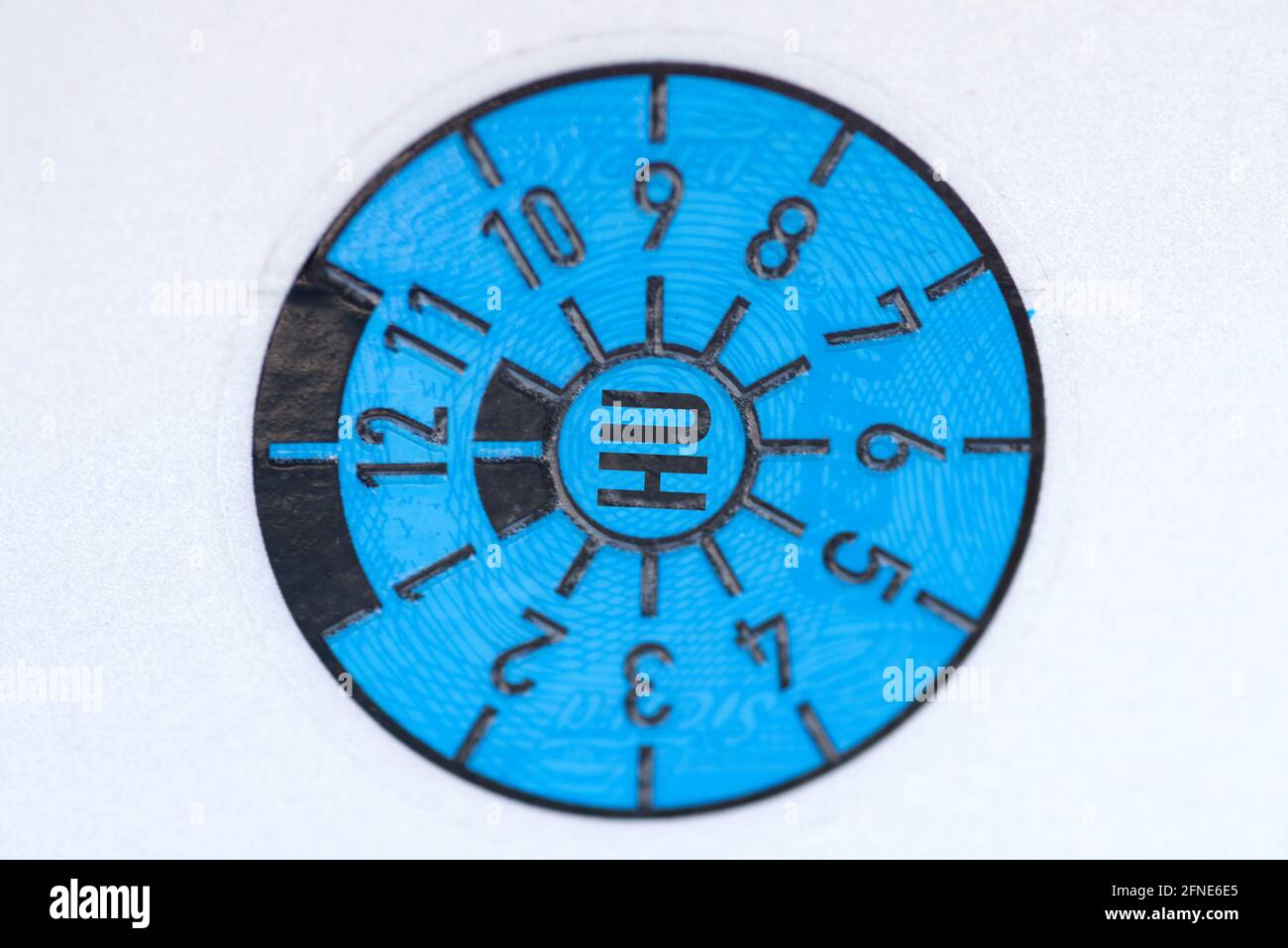 A blue Technical Inspection Association badge on the car license plate Stock Photo