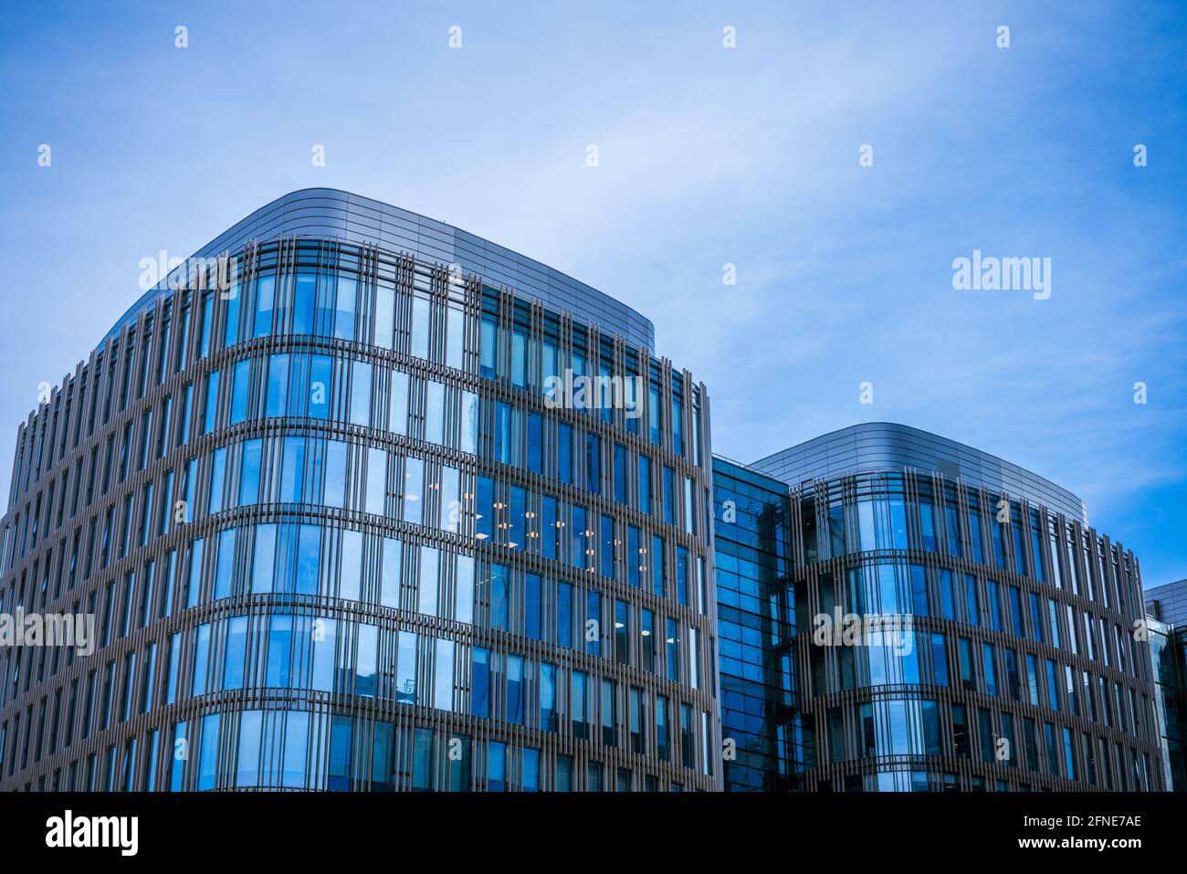 Glass facades of office buildings against a blue sky Stock Photo - Alamy