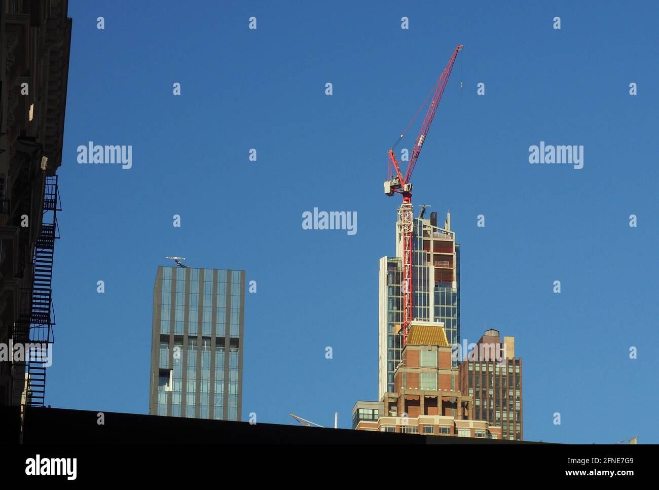 New York city skyline with crane and silhouetted stairs Stock Photo