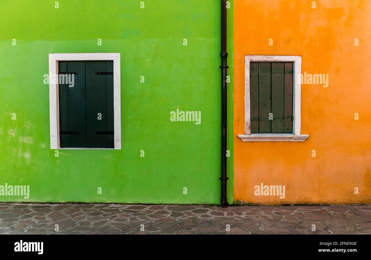 Green and orange wall, colorful house wall,window with closed shutters, colorful facade, Burano Island, Venice, Veneto, Italy Stock Photo