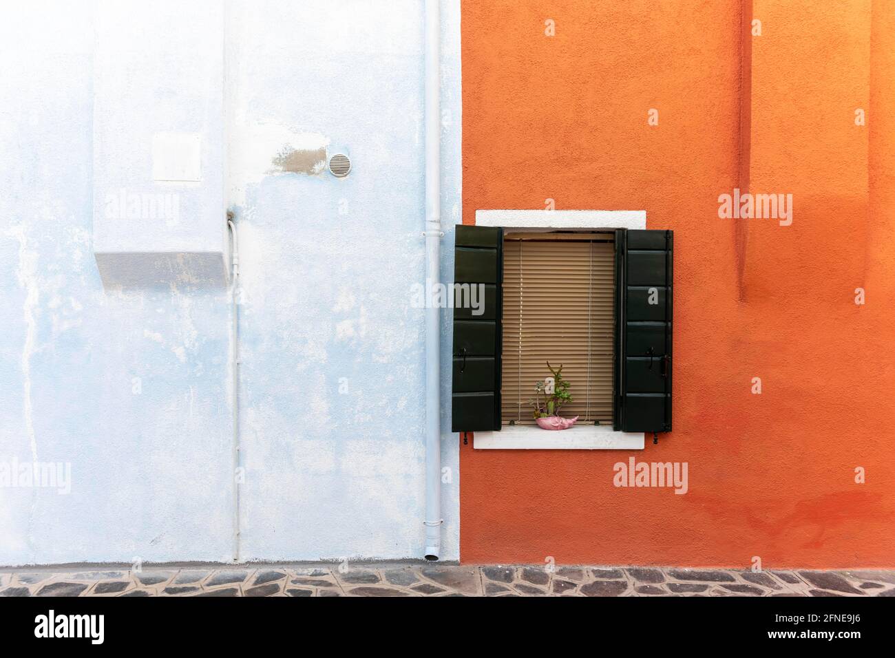 Window, orange and light blue wall, colorful house wall, colorful facade, Burano Island, Venice, Veneto, Italy Stock Photo