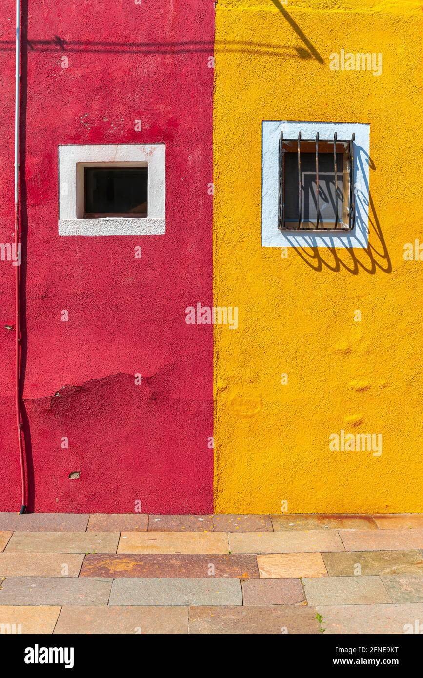 Red and yellow wall with window, colorful house wall, colorful facade, Burano Island, Venice, Veneto, Italy Stock Photo