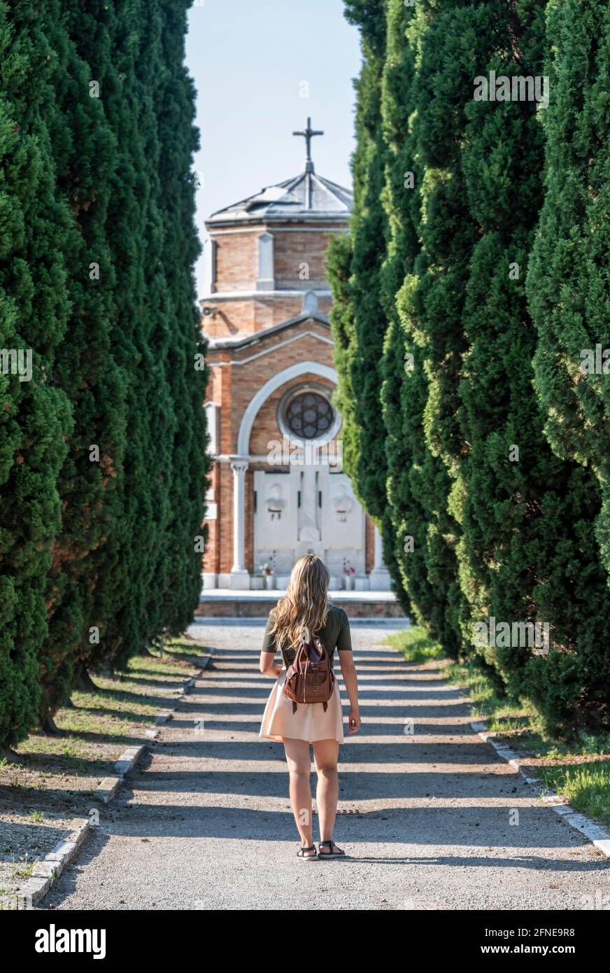 Young woman on the main path of the cemetery island San Michele, Venice, Italy Stock Photo