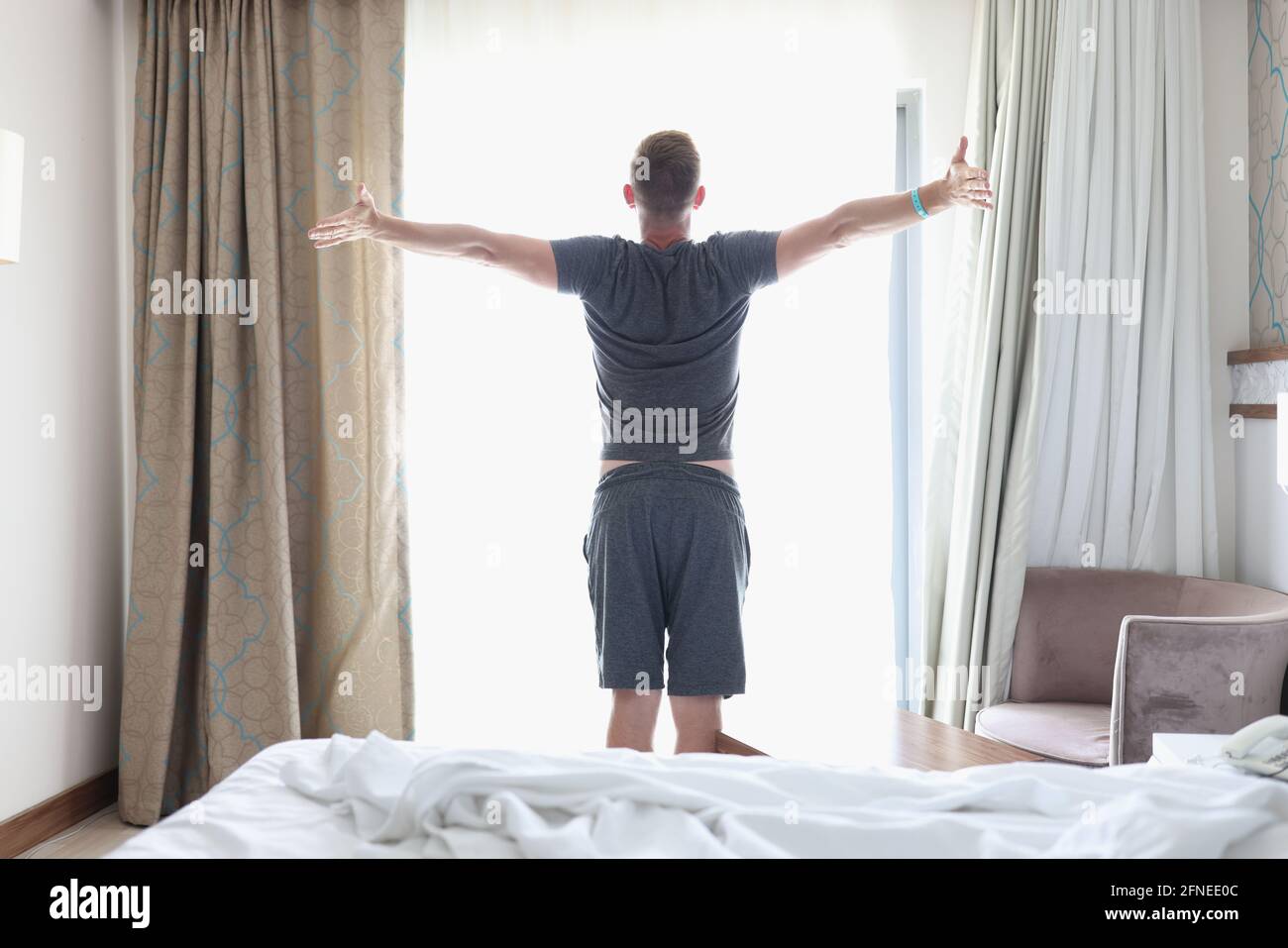 Successful man stands in bedroom near bright window Stock Photo Alamy