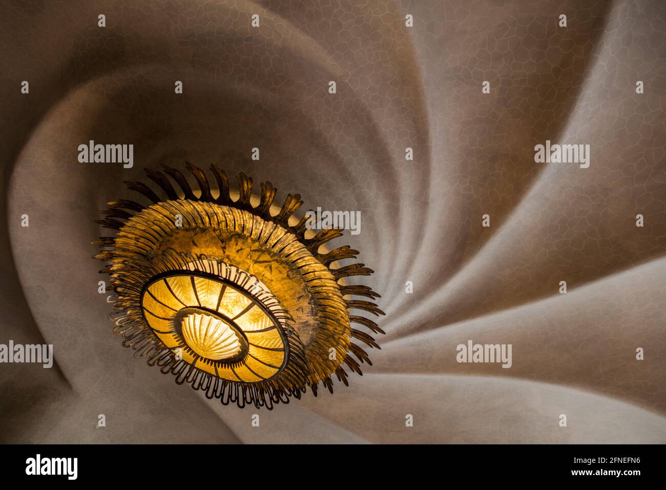 Spiraled ceiling and light  in the Casa Batlo in Barcelona, an iconic building designed by Antoni Gaudi Stock Photo