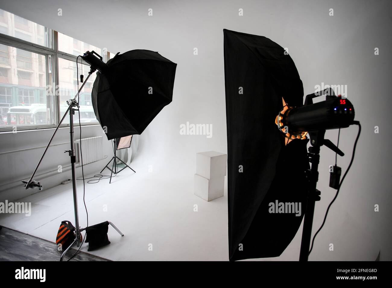 Photo studio, lighting fixtures, white endless background, white cubes. A professional  studio equipment Stock Photo - Alamy