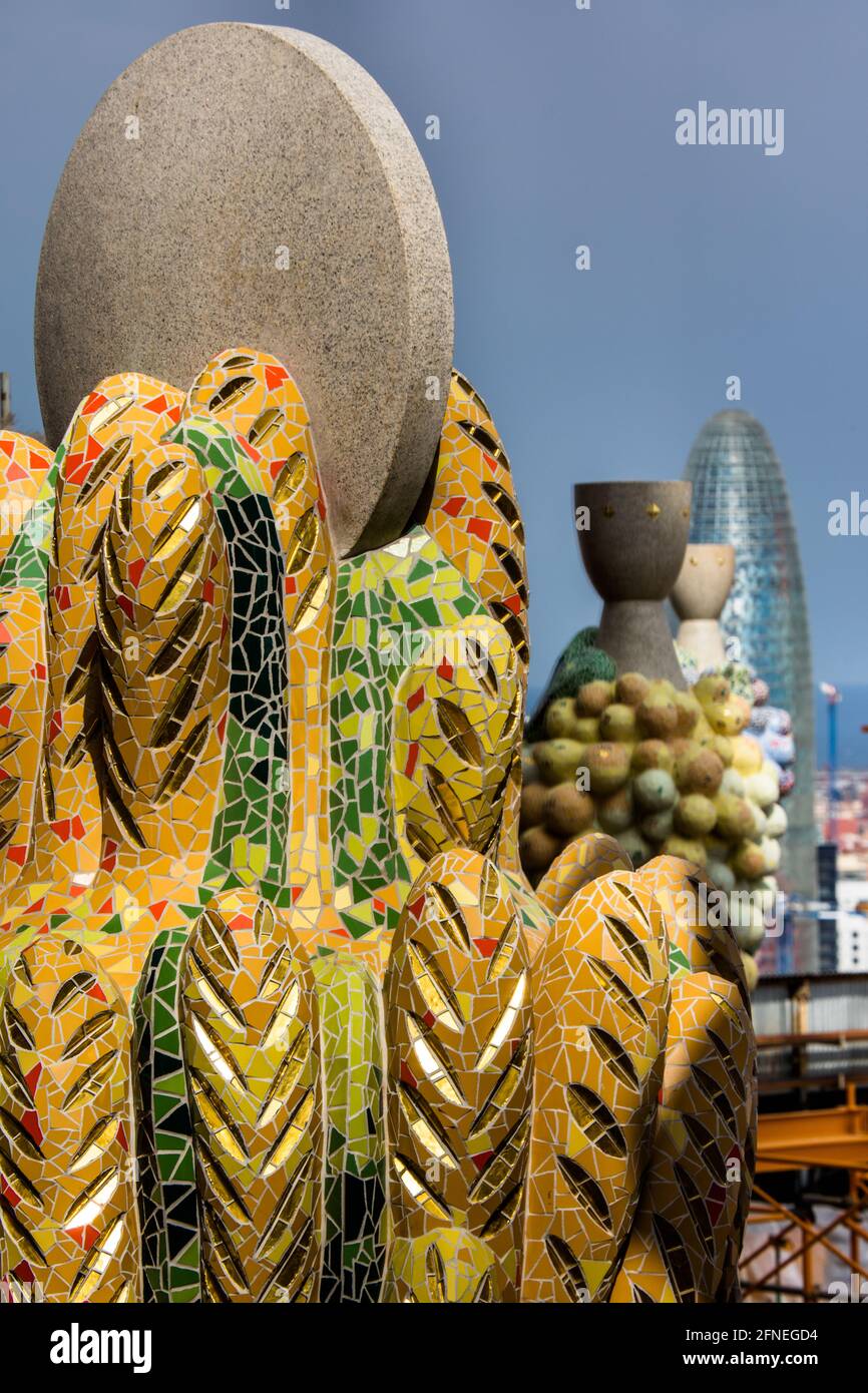 Tiled decorative flourishes atop the Basilica de la Sagrada Familia, overlooking the Barcelona skyline. Stock Photo