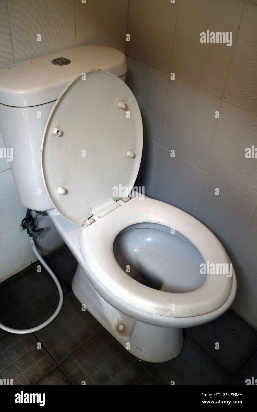 a white toilet seat with a black floor photo Stock Photo