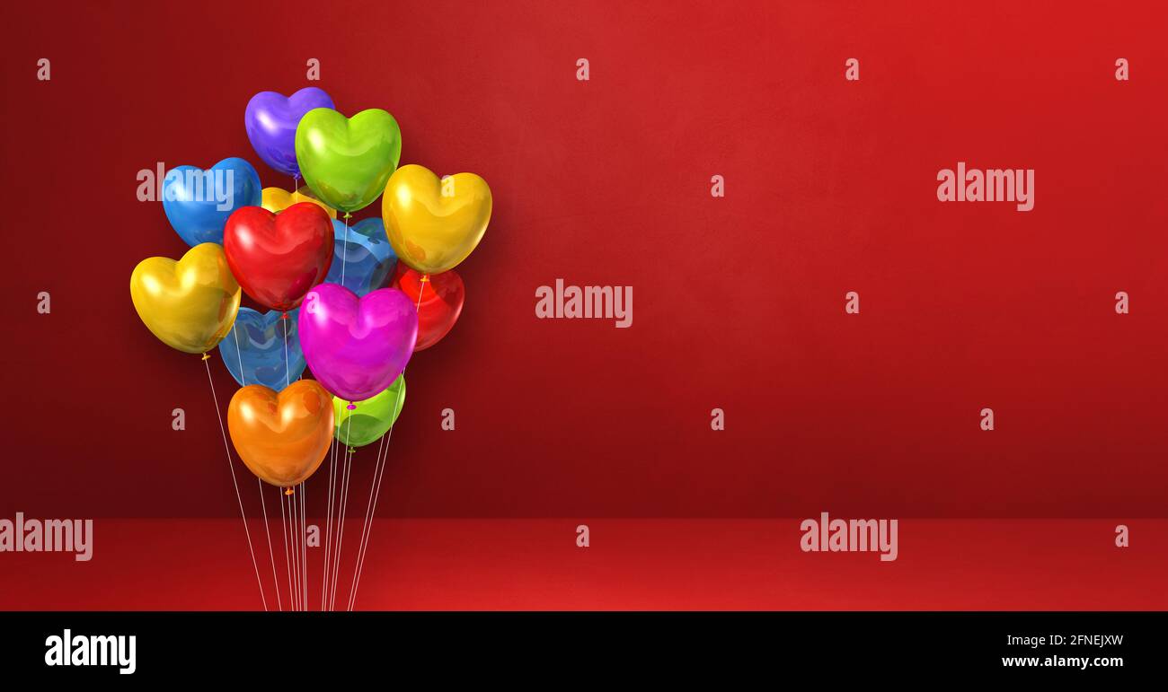 Colorful heart shape balloons bunch on a red wall background ...
