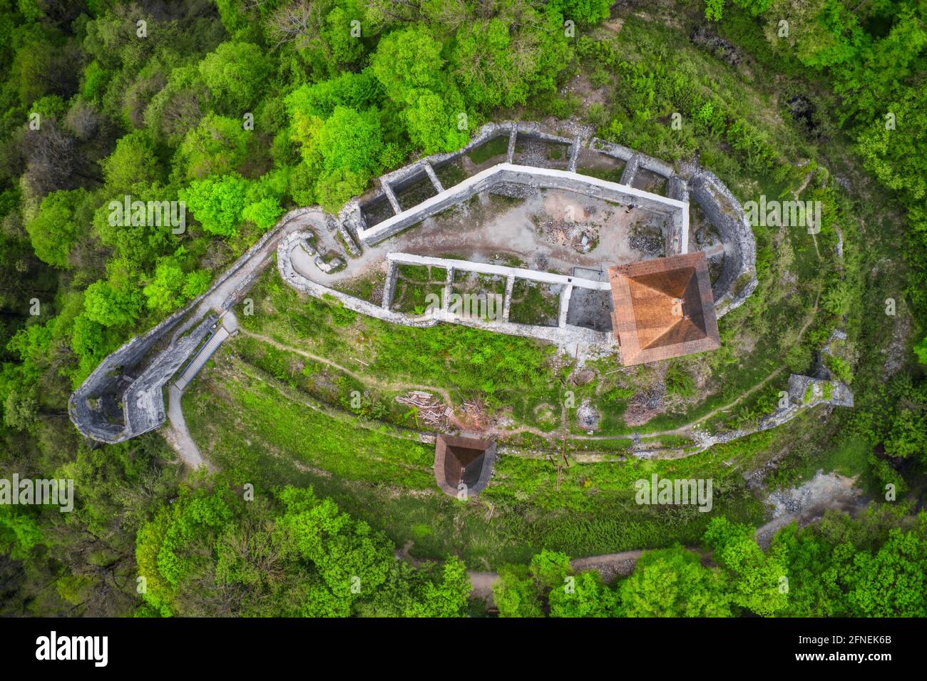 An aerial view of an old castle surrounded by trees on a hill in ...