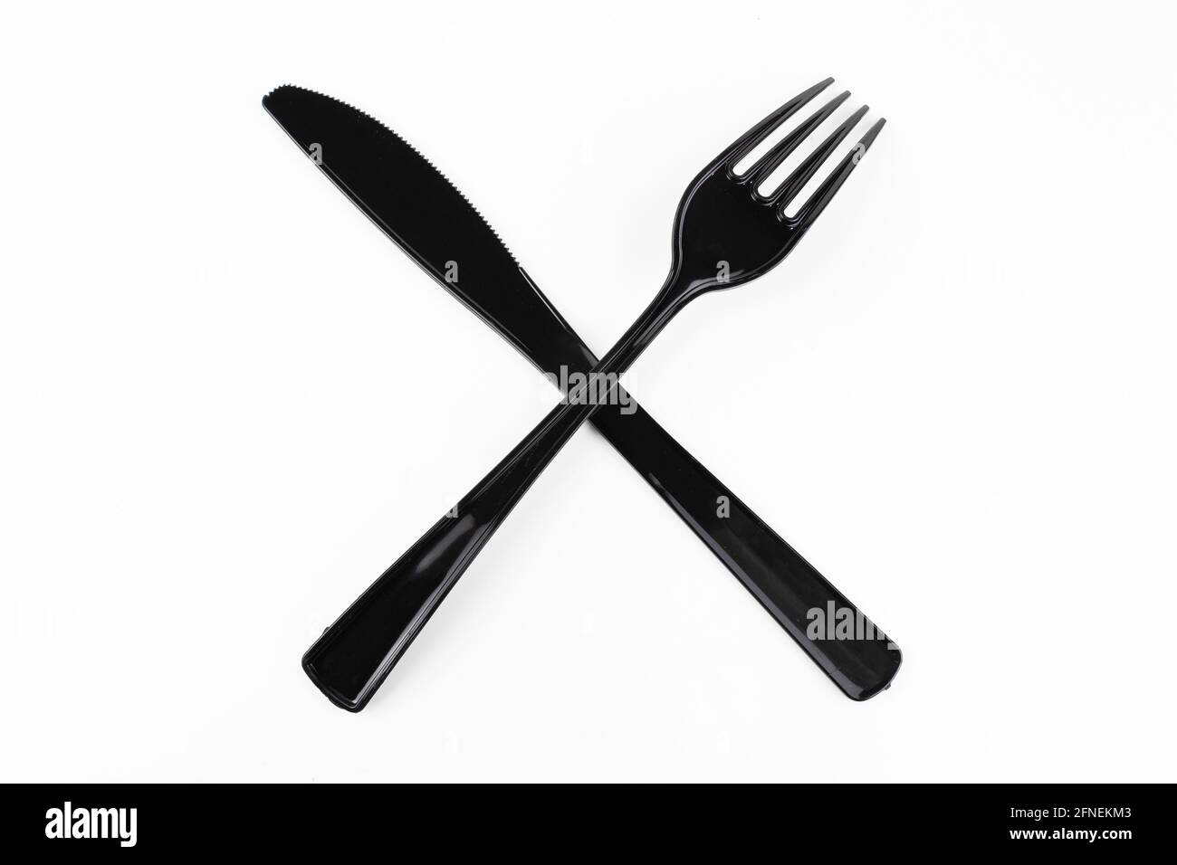 Black table fork and knife crossed on white background. Stock Photo