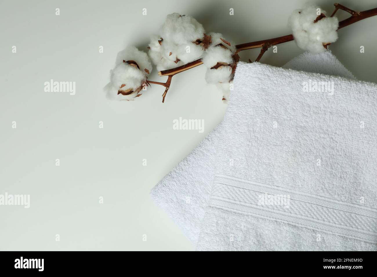 Clean folded towels and cotton on white background Stock Photo