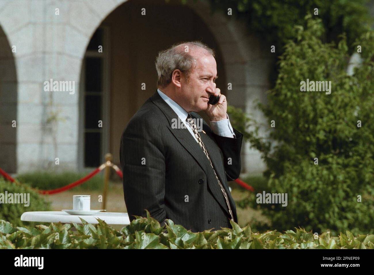 French Foreign Minister Hubert Vedrine, talks on the phone during the G-8 Foreign Ministers meeting on the terrace of the German government's guest house, Petersberg. [automated translation] Stock Photo